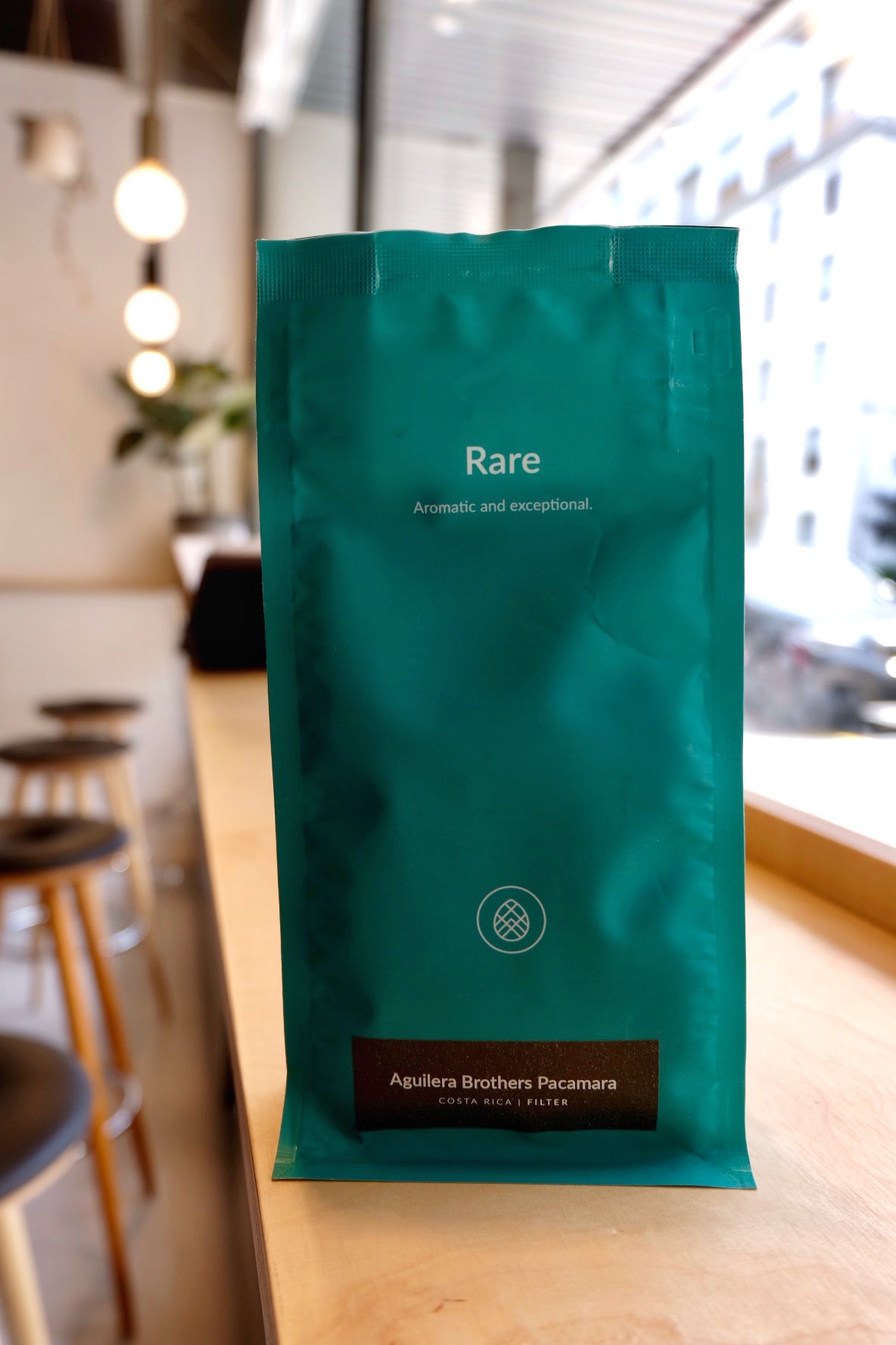 A white bag of coffee beans from Rosso Coffee Roasters